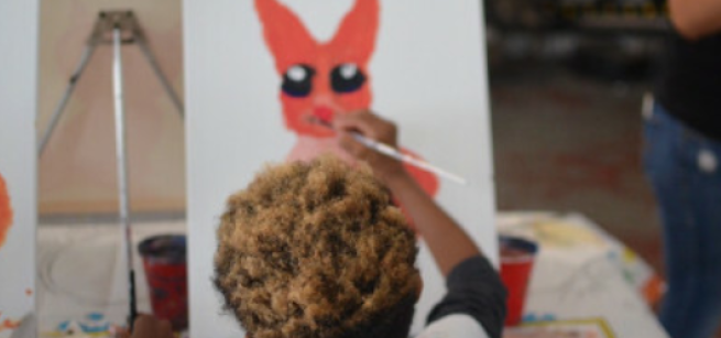 Child painting on a canvas. 