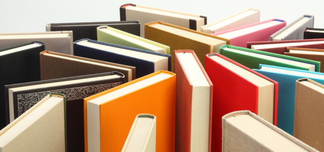 An assortment of hardcover books in standing position
