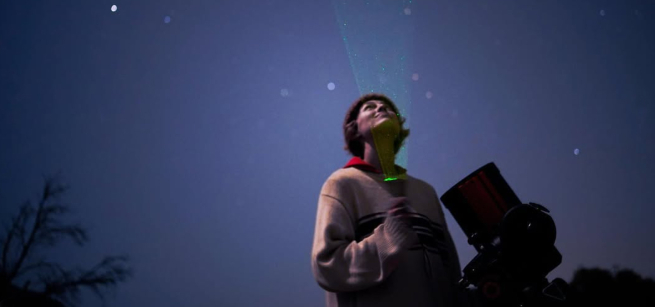 Astronomer Casey Cooper looks up at the night sky.
