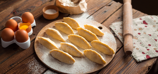 eleven empanadas on a round board