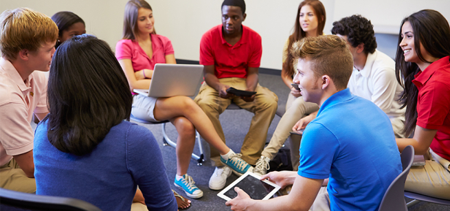 Teens sitting in a discussion circle.