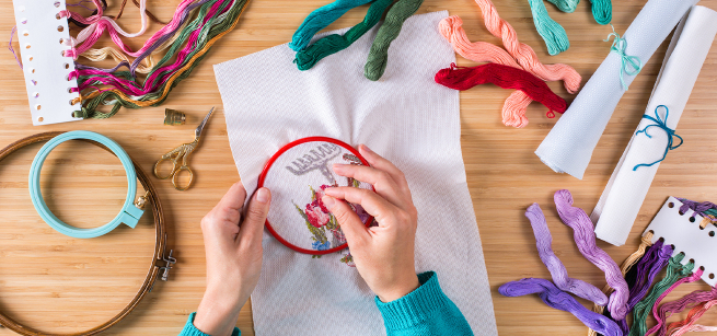 Two hands embroidering 