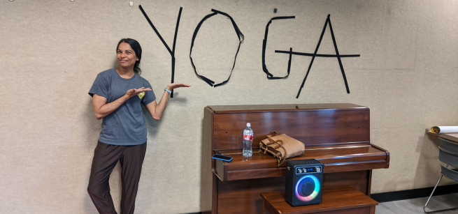 Photo of yoga teacher pointing to the word yoga