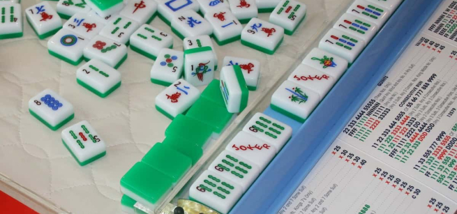 Image of the game of Mah Jongg tiles in mid-game.