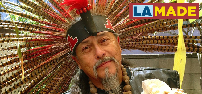 man with mustache wearing native head dress