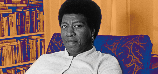 Author Octavia E. Butler sitting on a chair in front of a bookshelf