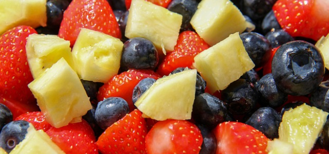 A color photograph of strawberries, pineapple and blueberries, Image by Pat from Pixabay