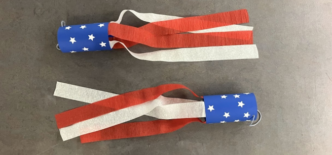 Two blue wind-socks, decorated with stars, with red and white streamers attached to the ends