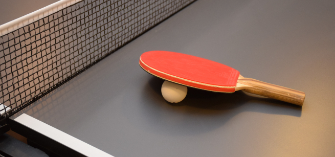 Ping Pong racket on table with net