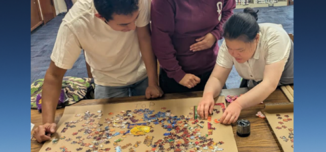People working on a puzzle