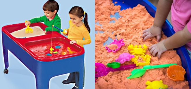 Two children playing at a sand and water table and a pair of small hands grabbing sand.  