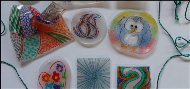 image of a number of shrinky dink amulets laid out on a white background