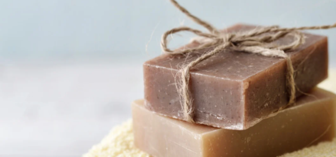 Two brown blocks of soap on a cream towel