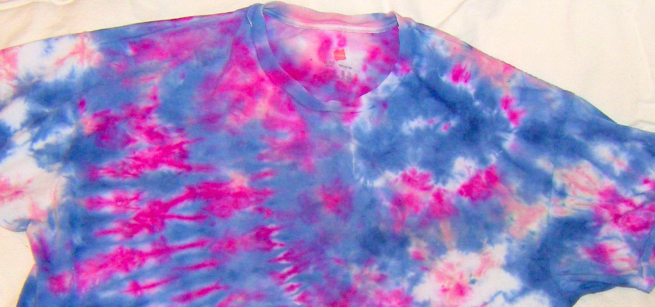 A vibrant tshirt that has been tie-dyed in pink and blue.