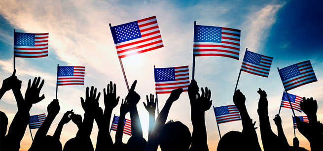 people's hands holding an American flag