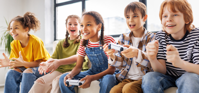 Young people sitting and playing video games with controllers in their hands.