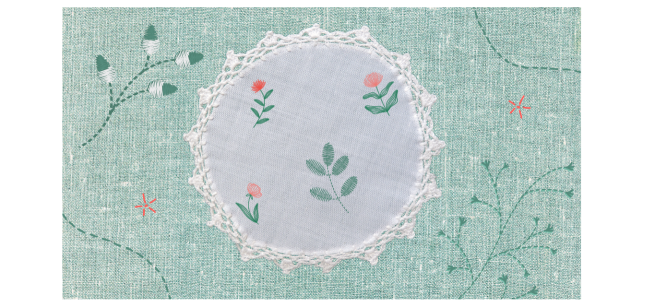 Textured light green and white fabric with flowers and green leaves embroidered on it.