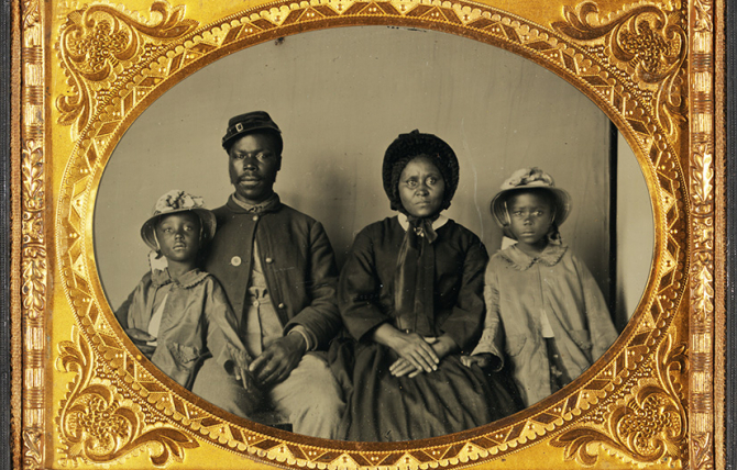 Quarter-Plate Ambrotype taken between 1863 and 1865. Image  depicts a Black Union Army private and his wife and twin daughters. 
