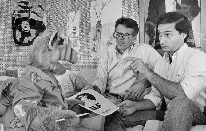 Writer and co-creator Tom Patchett, left, and voice actor Paul Fusco, right, voice are confronted with last-minute script changes from star ALF. Herald Examiner Collection, 1987