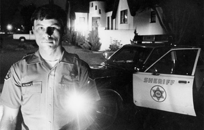 Sheriff’s Deputy Bill Phelton is shown during a late night patrol in Temple City, where attacks by the Night Stalker caused rising fear in the community. Michael Haering/Herald Examiner Collection, 1985.