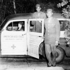 Dropping off soldiers ca. 1945 - Ethel Sissle (later Gordon), driving a Woodie station wagon for the Los Angeles Chapter of the American Red Cross, drops off two soldiers. Shades of L.A. Photo Collection.