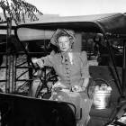 Valley historian  and pioneer Frances Muir Pomeroy pictured with the first bell used at North Hollywood High School and peaches, which  represent the days when North Hollywood was known as Lankershim, Home of the Peach.