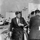 President John F. Kennedy exiting a vehicle.