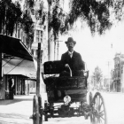 William K. Cowan sitting in a car, circa 1900. Cowan is the first car dealer in Los Angeles.
