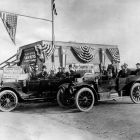 W.P. Whitsett’s real estate office in Van Nuys is pictured in 1911. In foreground, groups of men sitting in two different cars.