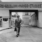 Actor Francis X. Bushman (1883–1966) walks from one of the entrance gates at the Metro-Goldwyn-Mayer Studios in Culver City. Known as the “King of the Movies”, Bushman's long acting career started in the 1910s when he became a popular matinee idol. 1953 – Security Pacific National Bank Collection 