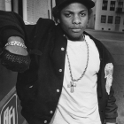 Eazy-E, 1989 – Steve Grayson/Herald Examiner Collection, Born Eric Wright, he was also known as The Godfather of Gangsta Rap, performing both as a solo artist and with L.A. rappers Ice Cube and Dr. Dre in the hip hop group N.W.A..  Their highly controversial album Straight Outta Compton, released on Eazy-E’s label Ruthless Records, reached a remarkable double platinum status, despite a lack of radio airplay.