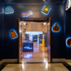 Entrance to the Something in Common exhibit, painted dark blue with lighted up icons of the featured groups.