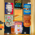 Fabric banners representing library programs hanging at the Getty Gallery in the Central Library.