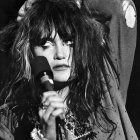 close up black and white photo of singer from band, X