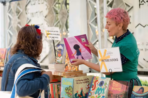 Librarian shows person books