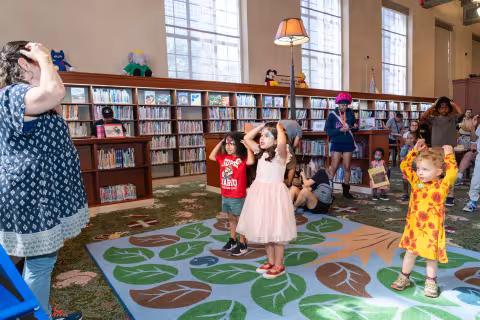Librarian leads children in movement exercise
