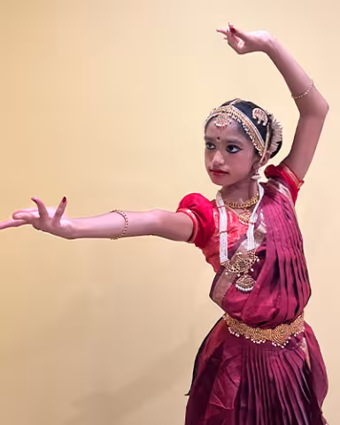 A dancer posing in traditional Indian clothing.