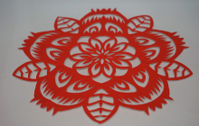 red paper cut into intricate circular design