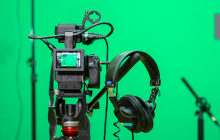 camera equipment in front of a green screen
