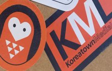 Orange, white and black stickers on a notebook.