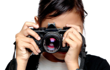 Woman hodling a camera in front of her face