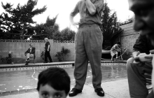 black and white photo of family around backyard pool