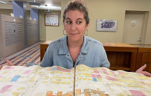 artist in front of large open book