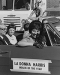 vintage b&w photo of ladies in a car with a sign that read La Donna Harris, Indian of the year