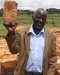 man holding up a Clay Water Brick