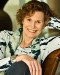 Judy Blume smiling sitting in a chair