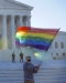 man waving rainbow flag