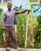 Ron Finley in a garden holding a rake