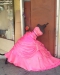 bright pink dress on a dress form fallen over in the street