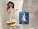 a puppet in a display case next to a book